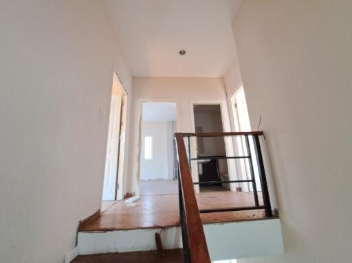 View of a hallway with doors leading to other rooms, indicative of an interior under renovation with visible construction details