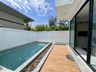 Private pool with wooden decking in a modern home
