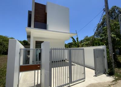 Modern two-story building with a unique architectural design and gated entrance