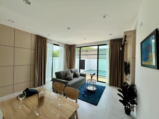 Modern living room with dining area and pool view
