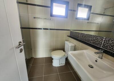 Modern bathroom with neutral color tiles and natural light