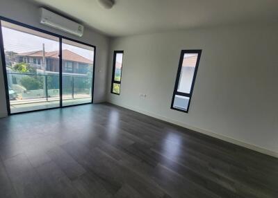 Spacious living room with large windows and ample natural light