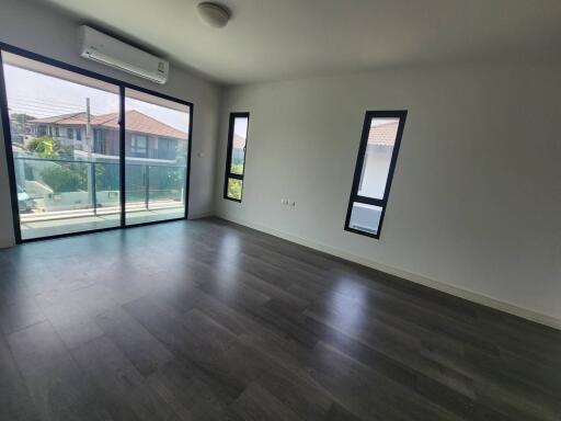 Spacious living room with large windows and ample natural light