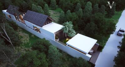 Aerial view of a modern luxury villa surrounded by trees