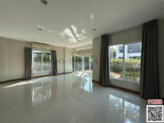 Spacious and bright empty living space with large windows and glossy floor