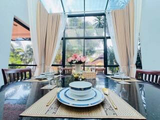 Elegant dining room with large window and fine tableware