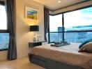 Modern bedroom with large windows and city view