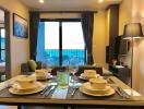 Modern dining area with set table and ocean view