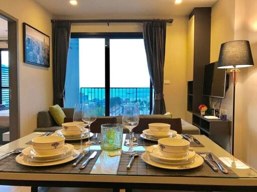 Modern dining area with set table and ocean view