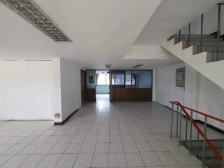 Spacious interior of an empty building with tiled flooring
