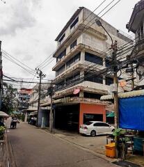 Urban residential building exterior with retail space on ground floor