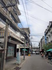 Urban street scene with buildings and overhead power lines