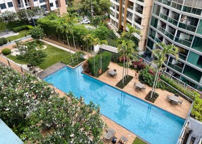 Apartment complex with pool, garden, and seating area