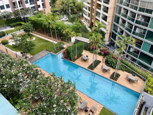 Apartment complex with pool, garden, and seating area