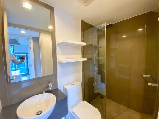 Modern bathroom interior with glass shower and mirrored vanity