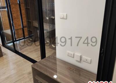 Modern entryway with wooden console and glass door