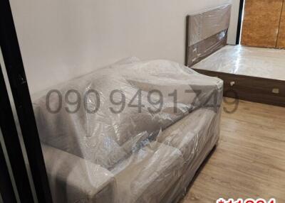 Newly furnished bedroom with covered furniture and clean design