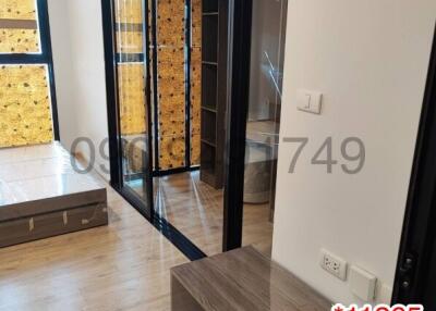 Modern bedroom with wooden floor and black framed glass door