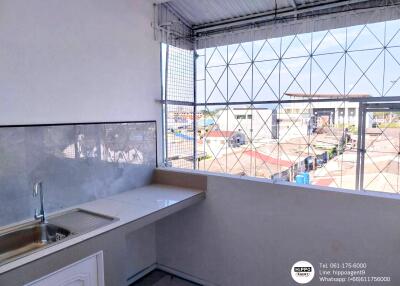 Spacious kitchen with large window and city view