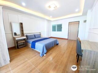 Spacious modern bedroom with a large bed and ample lighting