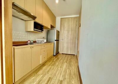 Modern kitchen with wooden cabinets and stainless steel appliances