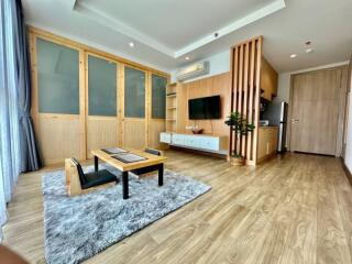 Spacious living room with modern furnishings and wooden accents