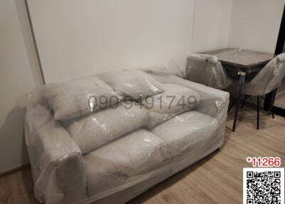 Newly delivered furniture wrapped in plastic in an apartment living room