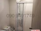 Modern bathroom with glass shower enclosures and tiled walls