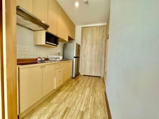 Modern kitchen with wooden cabinets and stainless steel appliances