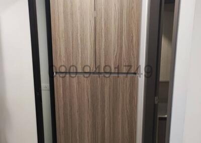 Modern wooden door inside a building corridor
