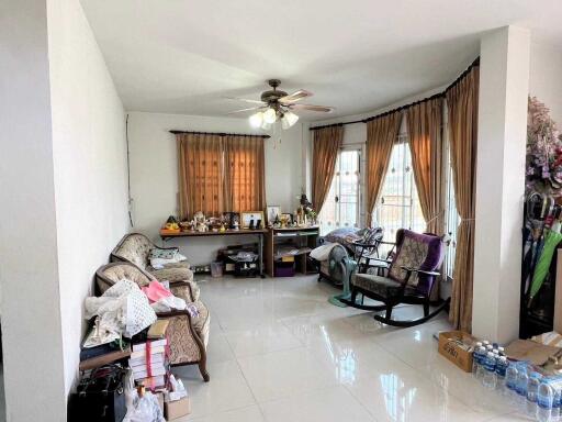 Spacious living room with natural light and multiple seating areas