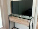 Modern bedroom interior with a television and a console table