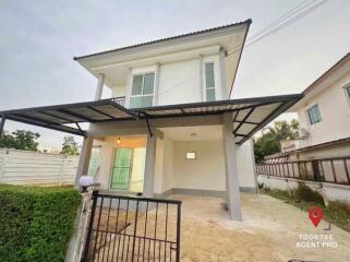 Two-story residential house with a carport