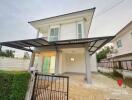 Two-story residential house with a carport