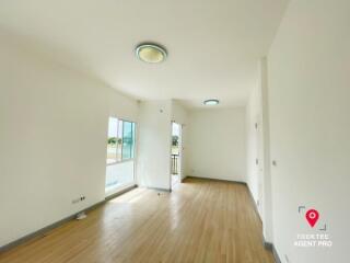 Spacious and well-lit living room with hardwood floors