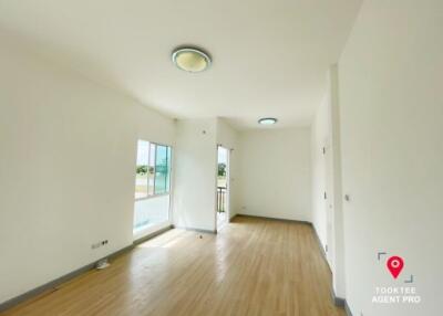 Spacious and well-lit living room with hardwood floors