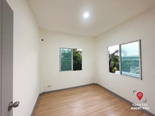 Bright and empty bedroom with large windows