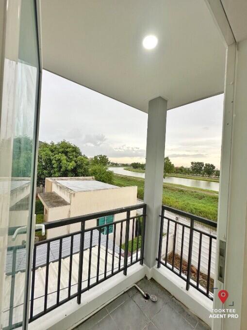 Spacious balcony with a view of the surrounding greenery and water