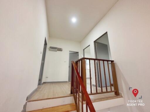 Bright interior view of a home staircase with wooden rails