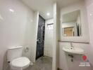 Modern bathroom with white tiles and glass shower