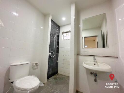 Modern bathroom with white tiles and glass shower