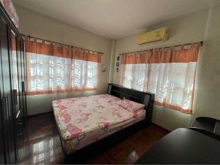 Cozy bedroom with natural light, air conditioning and modern furniture