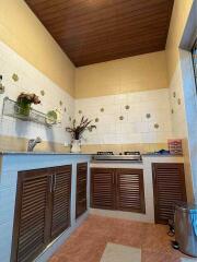 Modern kitchen with wooden ceilings and built-in cabinets