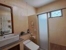 Spacious Bathroom with Modern Amenities and Beige Tile Decor