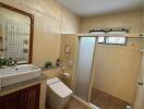 Modern bathroom with wooden floor and beige wall tiles