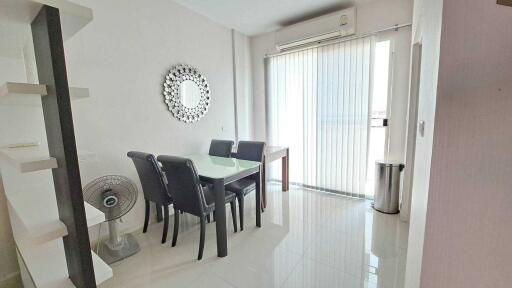 Bright dining area with modern furniture and tiled flooring