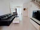 Spacious living room with modern furniture and staircase