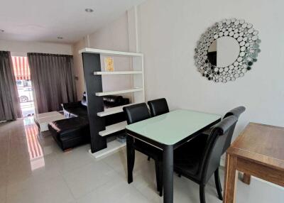 Modern living room with dining area and tiled flooring