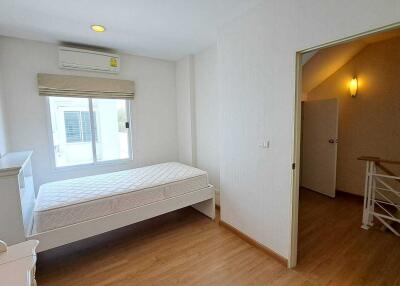 bright spacious bedroom with open door and window