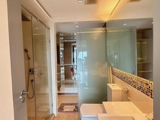 Modern bathroom interior with glass shower and tiled wall